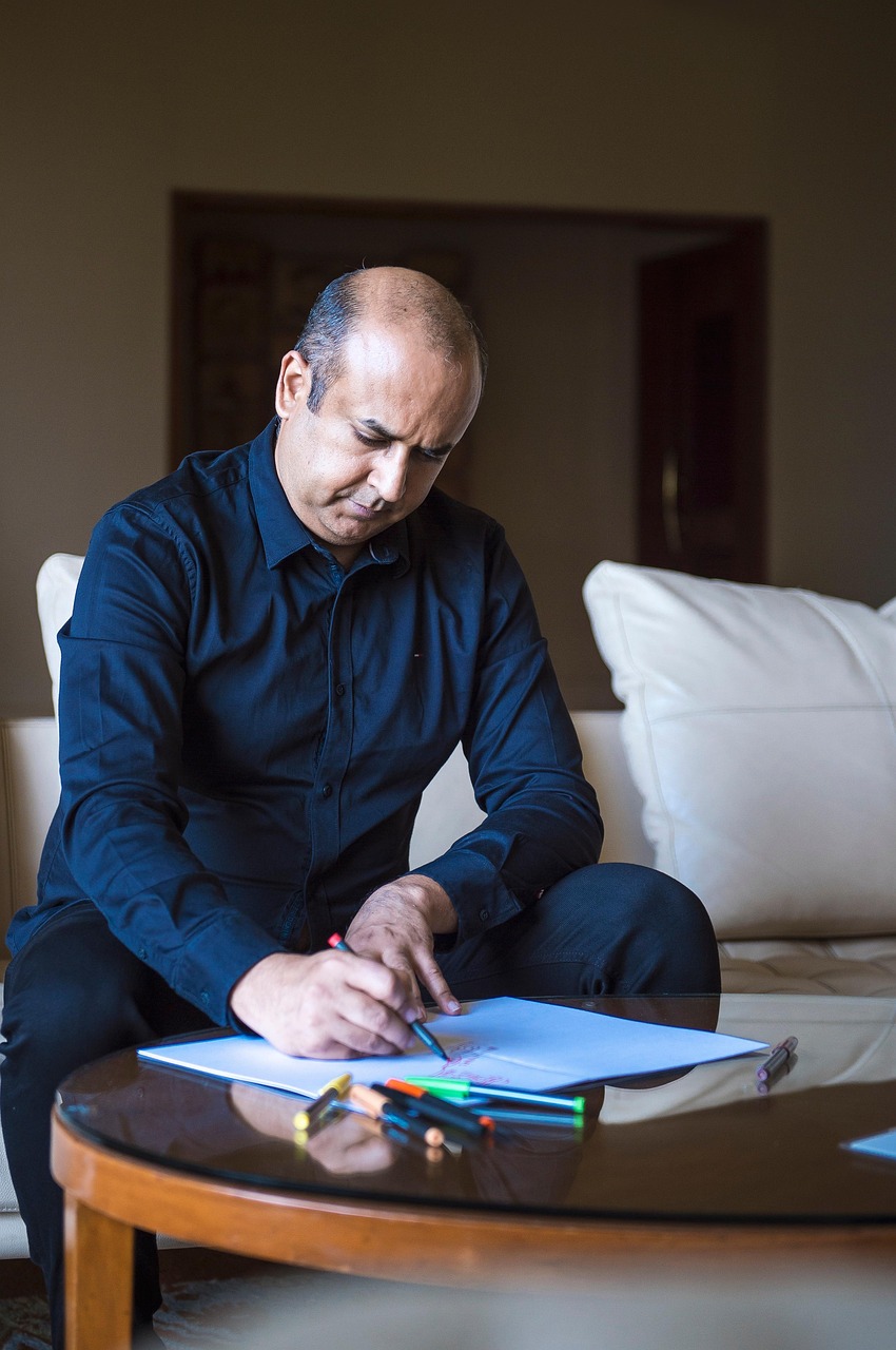 man, couch, table, notes, pen, sitting, drawing, writing, smart